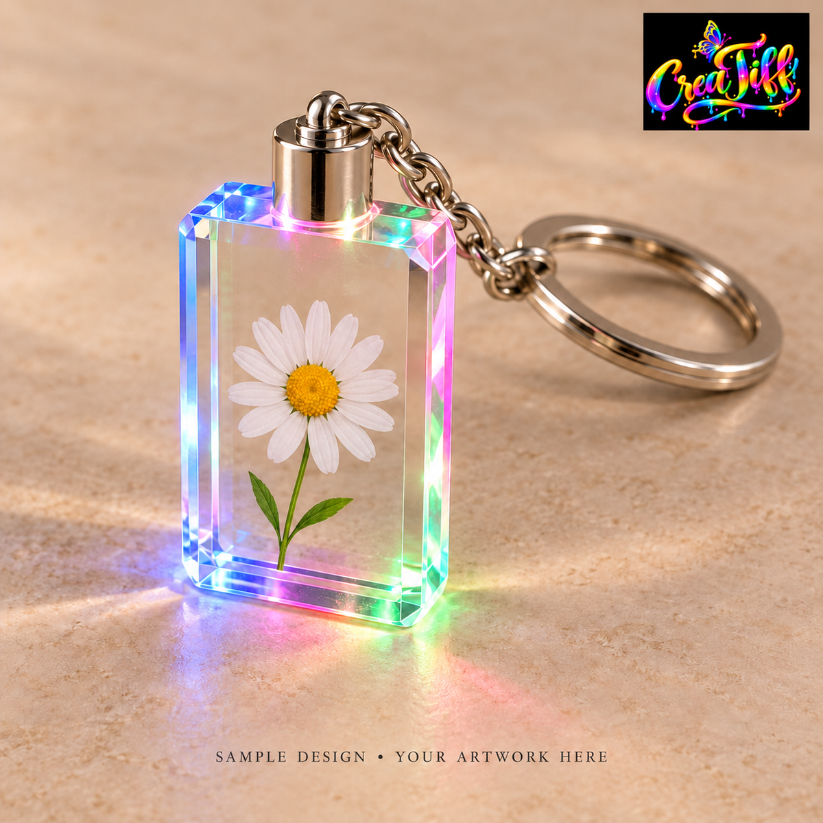 Illustrative sample of a rectangular LED crystal keychain with a daisy design; your artwork goes here. CreaTiff rainbow butterfly branding.